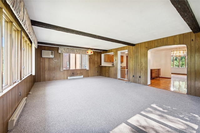 unfurnished room featuring a wall mounted AC, baseboard heating, wooden walls, and beam ceiling