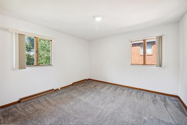 carpeted empty room with baseboard heating