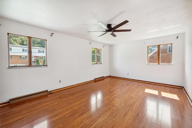 spare room with a baseboard radiator, ceiling fan, and hardwood / wood-style flooring