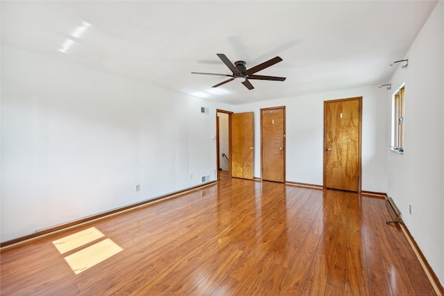 unfurnished bedroom featuring wood-type flooring and ceiling fan