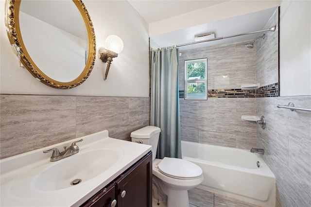 full bathroom featuring shower / bath combo with shower curtain, tile walls, toilet, and vanity