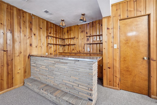 bar with wood walls and light carpet