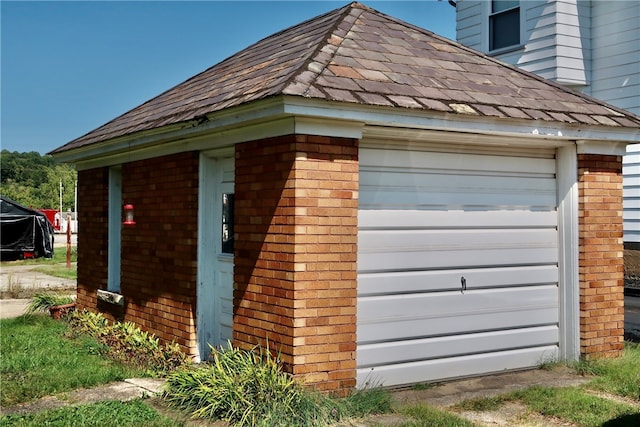 view of property exterior with a garage and an outdoor structure