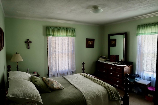 bedroom featuring carpet, crown molding, and a textured ceiling