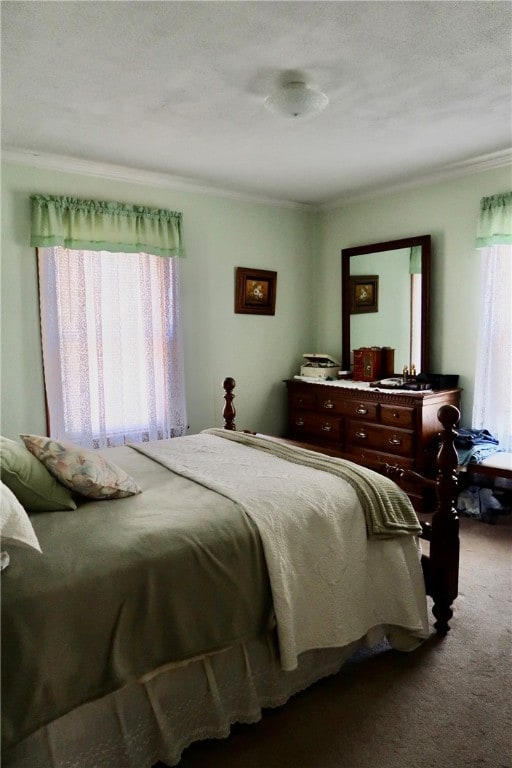 bedroom featuring ornamental molding, a textured ceiling, and carpet flooring