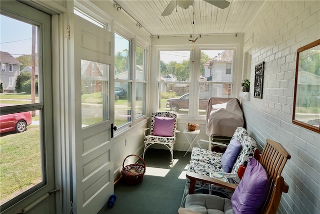 sunroom / solarium featuring ceiling fan and wooden ceiling