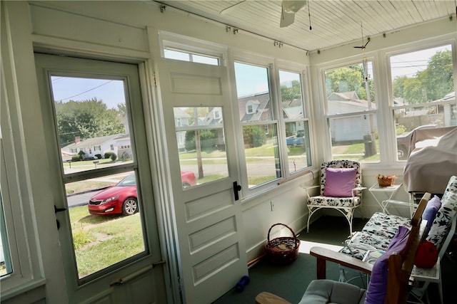 sunroom with a healthy amount of sunlight and ceiling fan