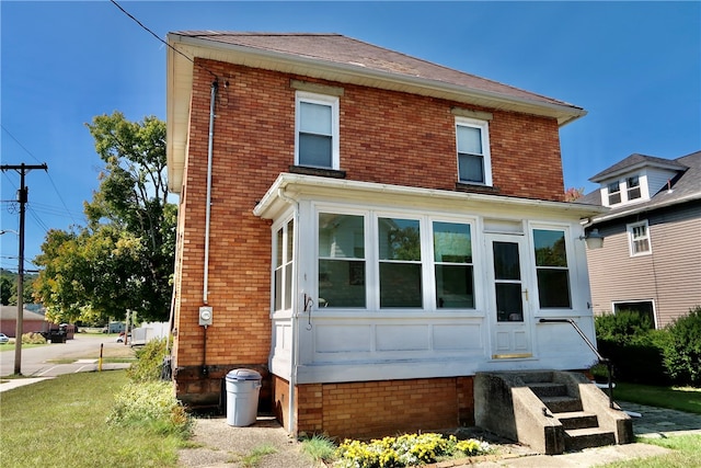 rear view of property with a sunroom