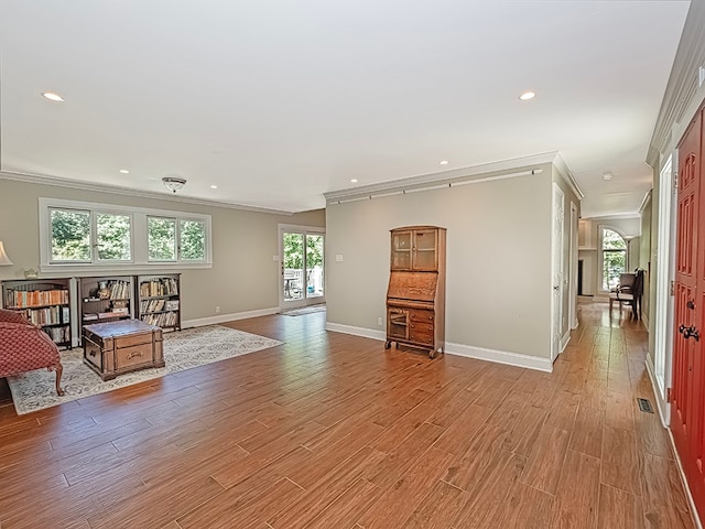 interior space featuring ornamental molding and light hardwood / wood-style floors