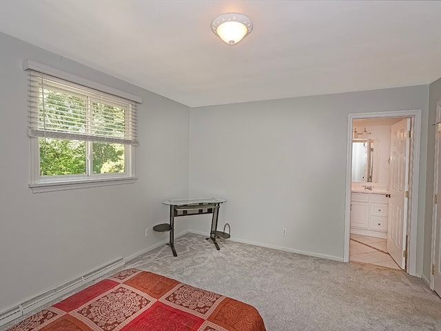 interior space with a baseboard heating unit and light colored carpet