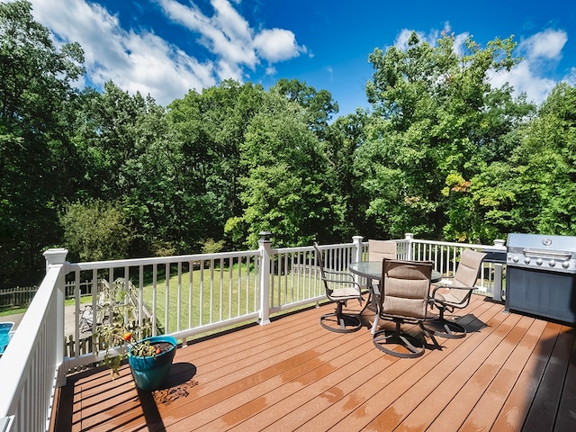 wooden terrace with a lawn