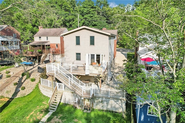 back of house featuring a deck