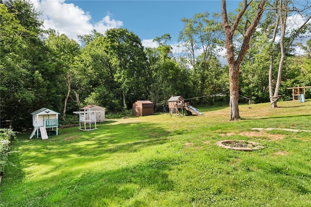 view of yard featuring a playground and a storage unit