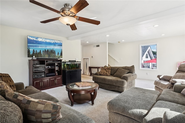 living room with ceiling fan, light colored carpet, and beam ceiling