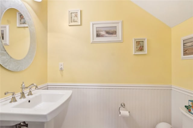 bathroom with sink and vaulted ceiling