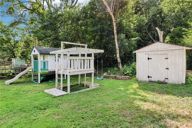 view of play area with a storage shed and a yard