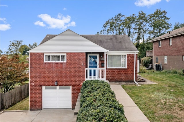 view of front of house with central air condition unit, a garage, and a front yard