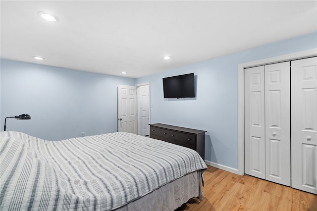 bedroom with a closet and light hardwood / wood-style floors