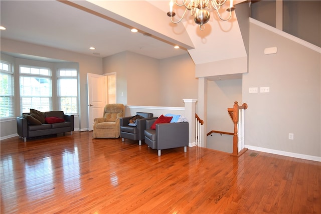 interior space featuring wood-type flooring, beamed ceiling, and an inviting chandelier