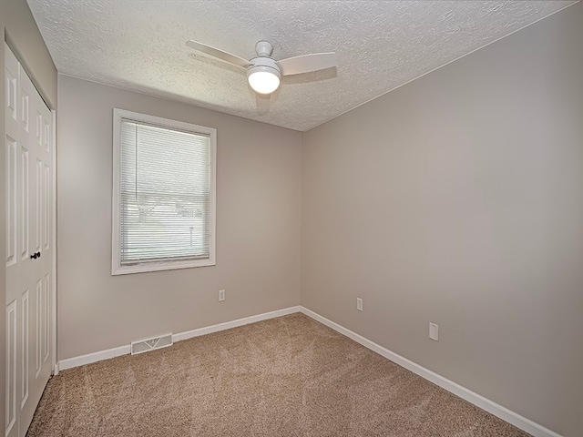 interior space with a textured ceiling and ceiling fan