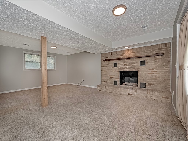 unfurnished living room with carpet floors, a fireplace, and a textured ceiling