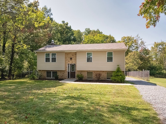 bi-level home with a front lawn