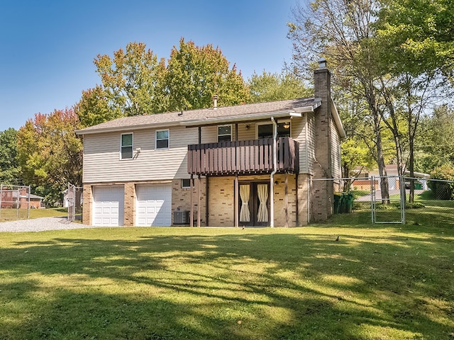 view of front of house featuring cooling unit, a garage, a balcony, and a front yard