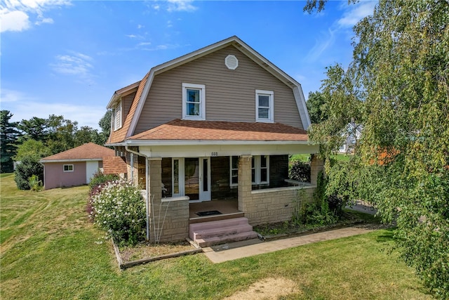 view of front of home featuring a front lawn and covered porch