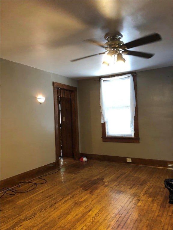 spare room featuring ceiling fan and dark hardwood / wood-style floors