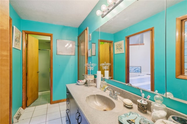 bathroom with a textured ceiling, vanity, tile patterned floors, and plus walk in shower