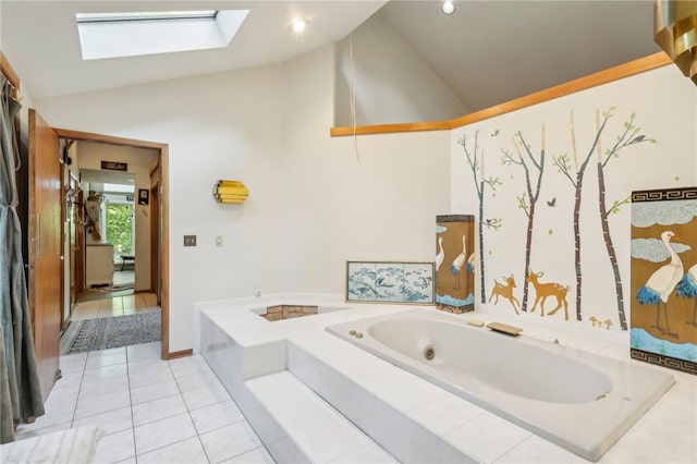 bathroom with vaulted ceiling with skylight and tiled tub