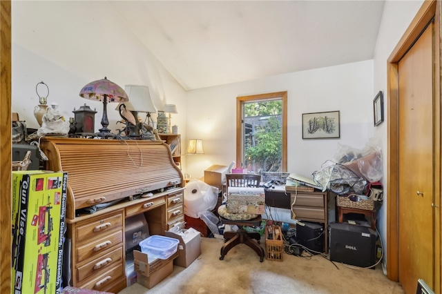 home office with vaulted ceiling and light colored carpet