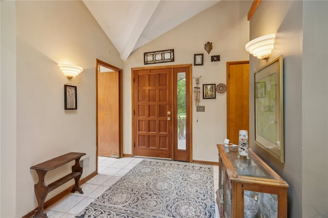 entrance foyer with vaulted ceiling and light tile patterned floors