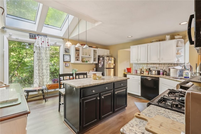 kitchen featuring white cabinets, pendant lighting, black dishwasher, and stainless steel refrigerator