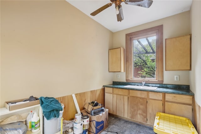 kitchen with light tile patterned floors, light brown cabinets, sink, and ceiling fan