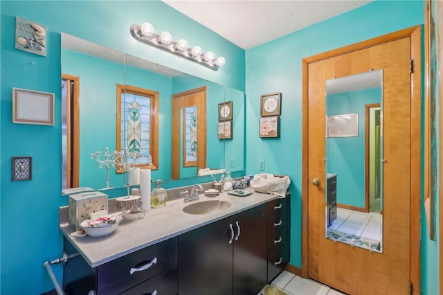 bathroom featuring tile patterned flooring and vanity