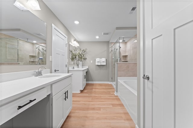 bathroom with vanity, separate shower and tub, and hardwood / wood-style floors