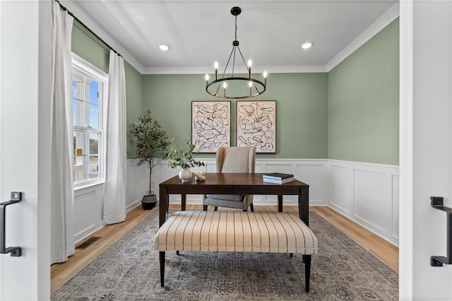 office with ornamental molding, light hardwood / wood-style flooring, and a chandelier