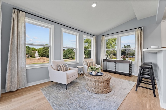 sitting room with vaulted ceiling and light hardwood / wood-style floors