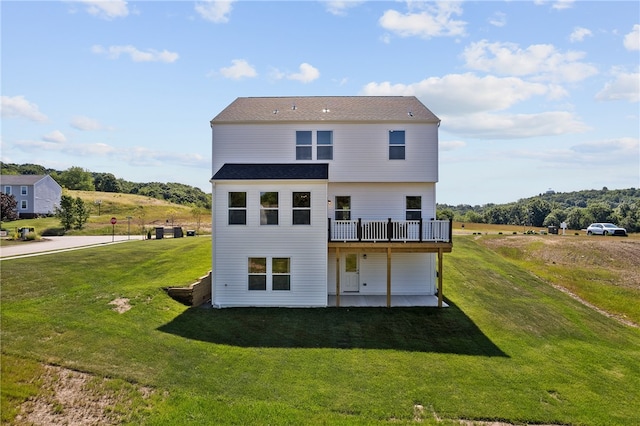 back of property with a lawn and a rural view