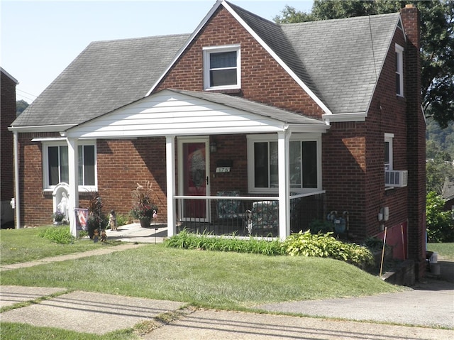 view of front of home with a front yard and covered porch