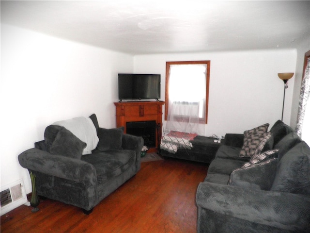 living room with dark hardwood / wood-style flooring