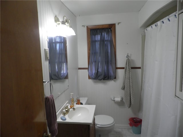 bathroom featuring vanity, toilet, and a shower with shower curtain