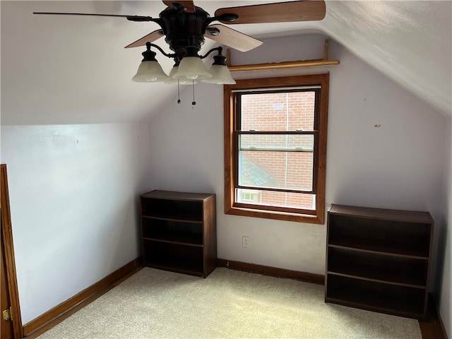 additional living space with ceiling fan, light colored carpet, and lofted ceiling