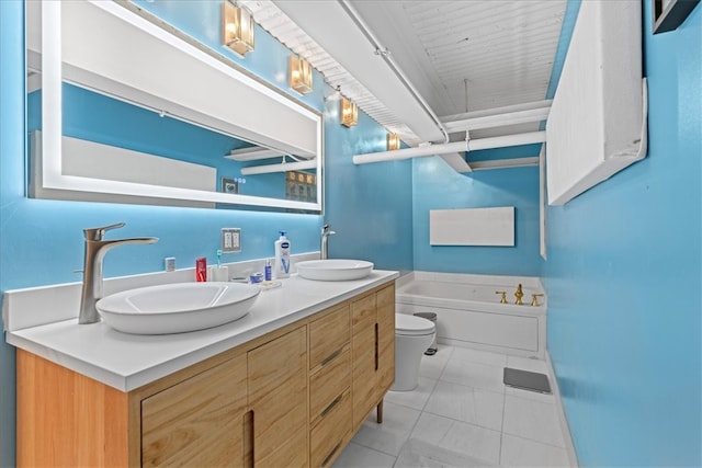 bathroom featuring tile patterned flooring, vanity, toilet, and a bathing tub