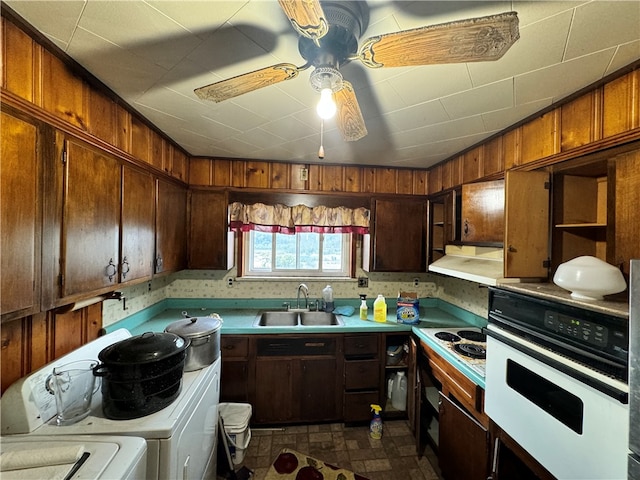 kitchen with white appliances, ceiling fan, sink, and separate washer and dryer