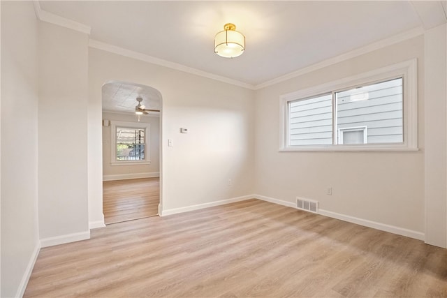 empty room with crown molding, light hardwood / wood-style flooring, and ceiling fan