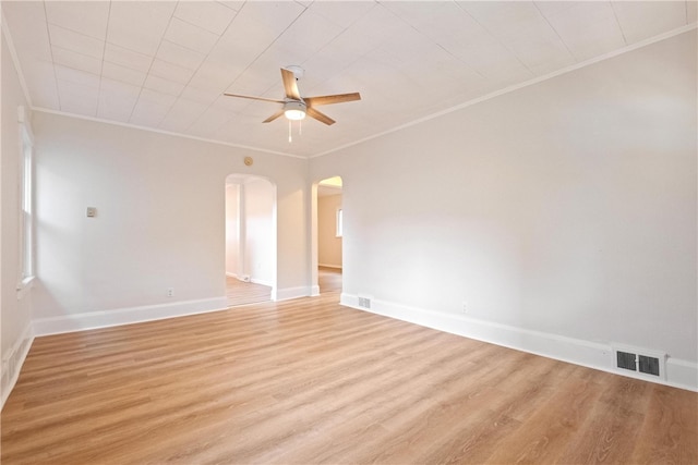 spare room featuring ceiling fan, ornamental molding, and light wood-type flooring