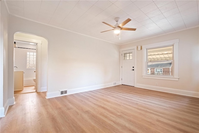 interior space with light wood-type flooring, ceiling fan, plenty of natural light, and ornamental molding