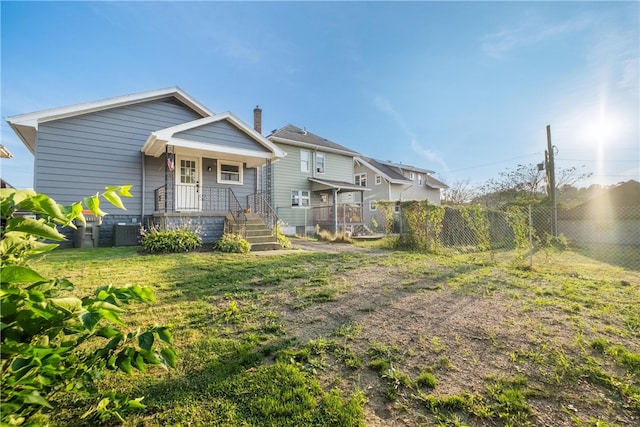 exterior space with central AC and a lawn